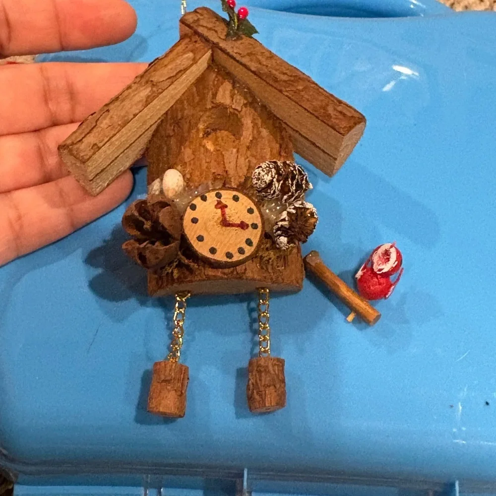 Christmas ornament depicting a wooden bird house clock